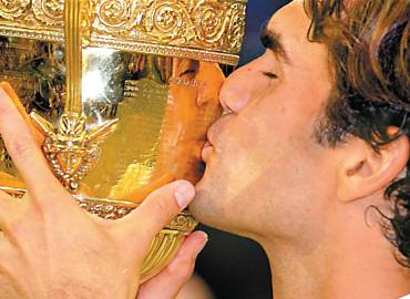 Federer beija sua stima taa de Wimbledon