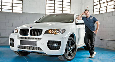 O empresrio Adriano Amaral e seu BMW X6, que tem 4,87 m de comprimento e 1,98 m de largura