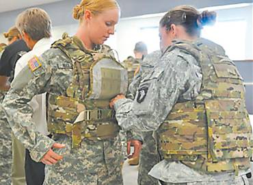 Soldado norte-americana veste prottipo de colete feminino em uma base militar nos EUA