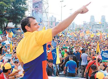 Rival de Hugo Chvez na eleio presidencial, Henrique Capriles acena a seus apoiadores durante comcio que lotou importante avenida da capital Caracas