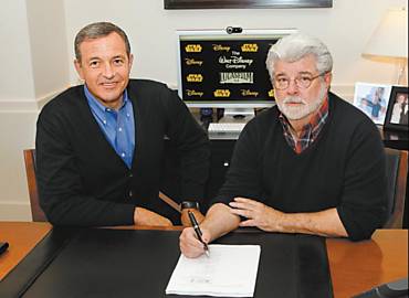 Diretor executivo da Disney Bob Iger e George Lucas assinam documentos na Califrnia