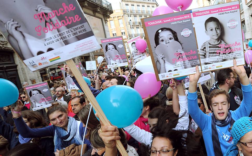 Manifestantes exibem cartazes em protesto ao projeto de lei que autoriza o casamento gay e a adoção por casais do mesmo sexo na França