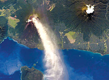 O vulco papuano Ulawun (centro-esquerda da imagem) lanando cinzas na atmosfera