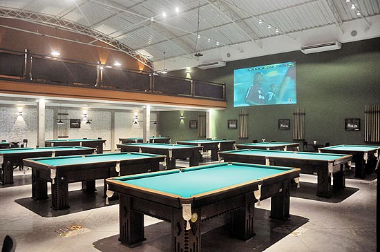 Ambiente do Pompeia Snooker Bar, que possui salão com pé-direito alto e conta com 16 mesas de sinuca