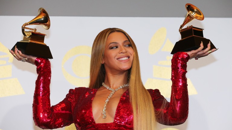 Beyonce holds the awards she won at the 59th Annual Grammy Awards in Los Angeles