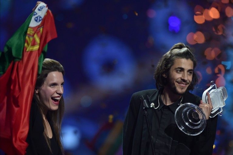 Portuguese singer representing Portugal with the song "Amar Pelos Dios" Salvador Vilar Braamcamp Sobral aka Salvador Sobral (R) holds the trophy as he celebrates with his sister Luisa Sobral on stage 