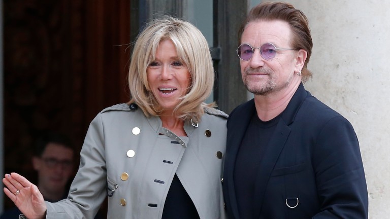 Brigitte Macron the wife of French President Emmanuel Macron, left, and founder of the non-governmental organization ONE, U2 singer Bono, pose for the media after a meeting at the Elysee Palace, in Pa