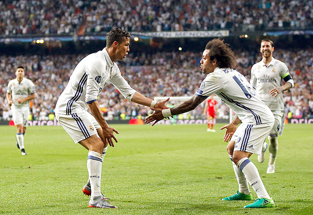 Real Madrid's Cristiano Ronaldo, left, celebrates with Marcelo after scoring his side's third goal during the Champions League quarterfinal second leg soccer match between Real Madrid and Bayern Munich at Santiago Bernabeu stadium in Madrid, Spain, Tuesday April 18, 2017. (AP Photo/Daniel Ochoa de Olza) ORG XMIT: XAF169