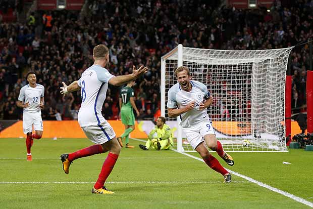 England's Harry Kane, right, celebrates after scoring the opening goal of his team during the World Cup Group F qualifying soccer match between England and Slovenia at Wembley stadium in London, Thursday, Oct. 5, 2017. England won 1-0. (AP Photo/Frank Augstein) ORG XMIT: XTS136