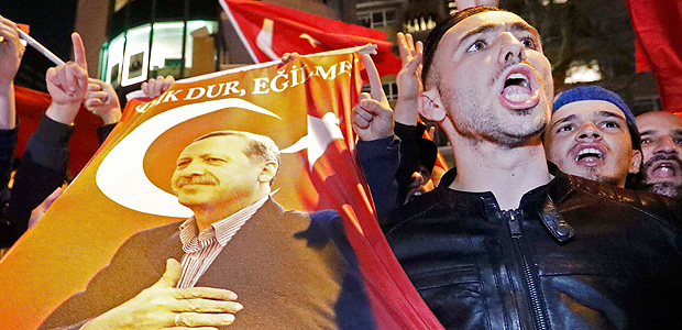 Demonstrators with banners of Turkish President Recep Tayyip Erdogan gather outsidethe Turkish consulate to welcome the Turkish Family Minister Fatma Betul Sayan Kaya, who decided to travel to Rotterdam by land after Turkish Foreign Minister Mevlut Cavusoglu's flight was barred from landing by the Dutch government, in Rotterdam, Netherlands March 11, 2017. REUTERS/Yves Herman TPX IMAGES OF THE DAY ORG XMIT: NED267