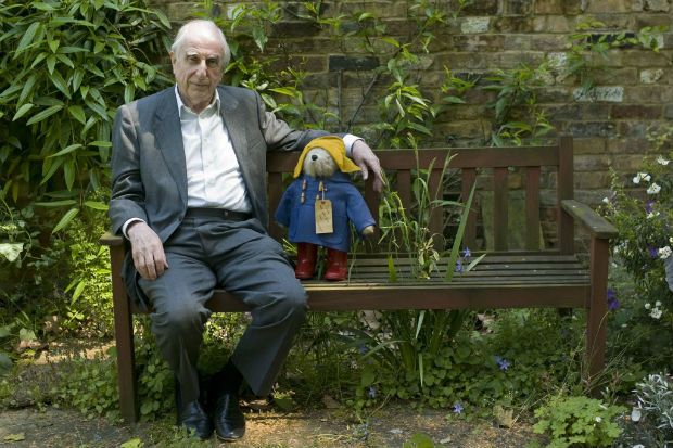 FILE - In this Thursday, June 5, 2008 file photo, British author Michael Bond sits with a Paddington Bear toy during an interview with The Associated Press in London. Publisher HarperCollins says Michael Bond, creator of globe-trotting teddy Paddington bear, died on Tuesday June 27, 2017, aged 91. (AP Photo/Sang Tan, File) ORG XMIT: LON116