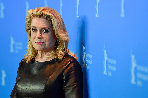 (FILES) This file photo taken on February 14, 2017 shows French actress Catherine Deneuve posing for photographers during a photocall for the film "Sage Femme" (The Midwife) in competition at the 67th Berlinale film festival in Berlin. Feminists and one of the women who accused fallen Hollywood mogul Harvey Weinstein of rape turned on French actress Catherine Deneuve on January 10, 2018 after she signed an open letter attacking the #MeToo movement for leading a witch-hunt against men. / AFP PHOTO / John MACDOUGALL