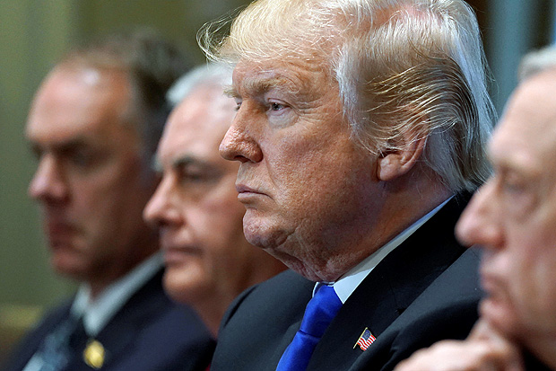 U.S. President Donald Trump, flanked by Interior Secretary Ryan Zinke, Secretary of State Rex Tillerson, and Defense Secretary James Mattis, holds a cabinet meeting at the White House in Washington, U.S., December 20, 2017. REUTERS/Jonathan Ernst ORG XMIT: WAS923