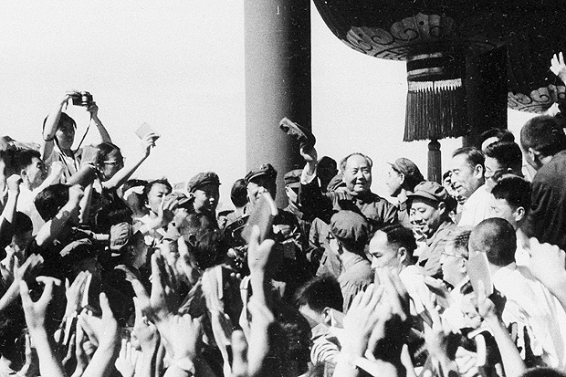 FILE - In this August 1966, file photo, Chinese leader Chairman Mao Zedong, center, waves as he meets with teachers and students from Beijing and other parts of China, in Beijing. A time of massive upheaval, violence and chaos, China's 1966-1976 Cultural Revolution, was launched 50 years ago by Communist Party leader Mao, who began it by purging officials considered insufficiently loyal. Over its course longstanding party officials, intellectuals and teachers came under violent attack, while traditional Chinese thought and culture were condemned along with foreign influences. (Photo via AP, File) ORG XMIT: XHG601
