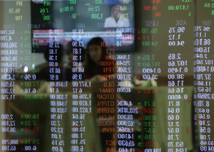 Numbers from the electronic stock board are reflected on the glass window of a restaurant during trading hours of the Philippine Stock Exchange at the financial district of Makati, Philippines, on Thursday, Nov. 10, 2016. Asian shares rallied Thursday, extending a surprising global recovery as Donald Trump's conciliatory acceptance speech comments helped soothe world financial markets spooked by his unexpected U.S. election victory. (AP Photo/Aaron Favila) ORG XMIT: XAF103