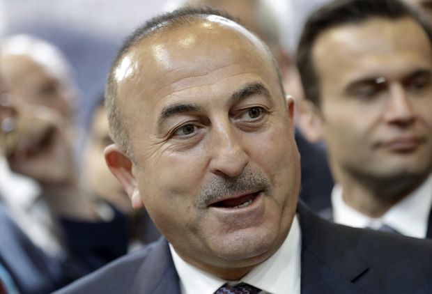 FILE - A Wednesday, March 8, 2017 file photo showing the Foreign Minister of Turkey, Mevlut Cavusoglu, during a visit of the booth of Turkey at the tourism fair ITB in Berlin, Germany. The Dutch government on Saturday, March 11, 2017, withdrew landing permission for the Turkish foreign minister's aircraft, escalating a diplomatic dispute between the two NATO allies over campaigning for a Turkish referendum on constitutional reform. (AP Photo/Michael Sohn, File) ORG XMIT: LON101