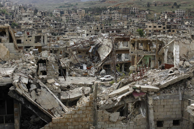 Carro passa em meio aos destroços de Zabadani, cidade assediada por cinco anos de ataques