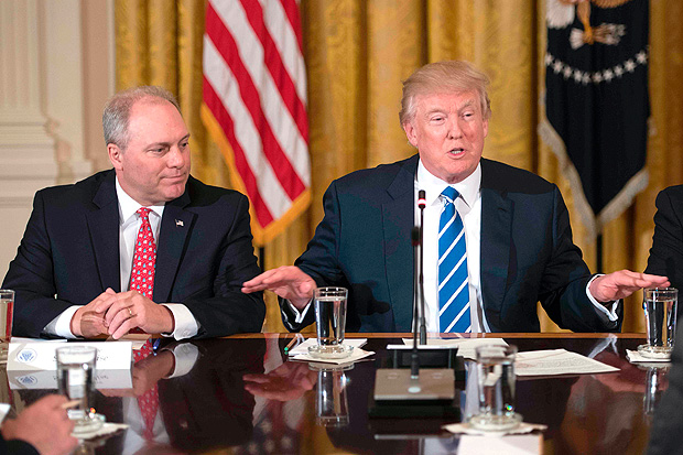 (FILES) This file photo taken on March 7, 2017 shows US President Donald Trump (R) speaking with US Congressman and Majority Whip Steve Scalise (L), R-Louisiana, during a meeting with the US House Deputy Whip team at the White House in Washington, DC. Senior Republican Congressman Steve Scalise was among several victims shot and wounded at a baseball practice ahead of an annual game between lawmakers in a Washington suburb, one of his colleagues said June 14, 2017.Fellow Republican lawmaker Mo Brooks told CNN that Scalise was shot in the hip, adding that at least two law enforcement officers and one congressional staffer were shot in Alexandria, Virginia. / AFP PHOTO / JIM WATSON ORG XMIT: JIM021