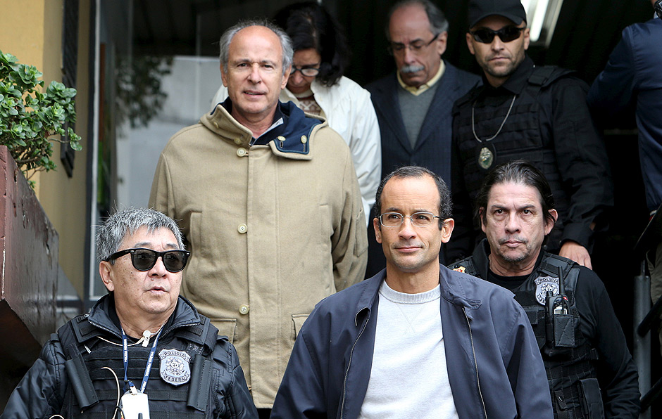 Marcelo Odebrecht (bottom, R), the head of Latin America's largest engineering and construction company Odebrecht SA, and Otavio Marques Azevedo (2nd L), CEO of Brazil's second largest builder Andrade Gutierrez, are escorted by federal police officer Newton Ishii (L) as they leave the Institute of Forensic Science in Curitiba, Brazil, June 20, 2015. REUTERS/Rodolfo Burher/File photo ORG XMIT: BRA101