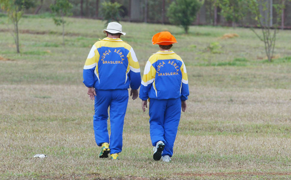 O presidente Lula e a primeira-dama, Marisa Letícia, caminham na Granja do Torto, em Brasília, com o agasalho da Força Aérea, depois de terem passado a noite em baile do clube da Aeronáutica