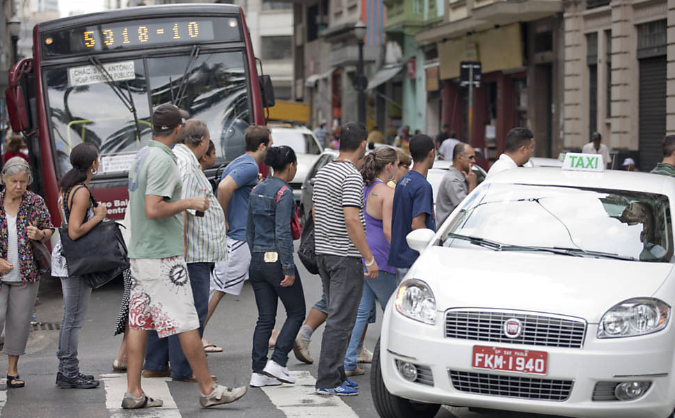 Pedestres atravessam rua do centro de São Paulo em meio a carros, motos e ônibus; centro lidera o ranking de atropelados <b>