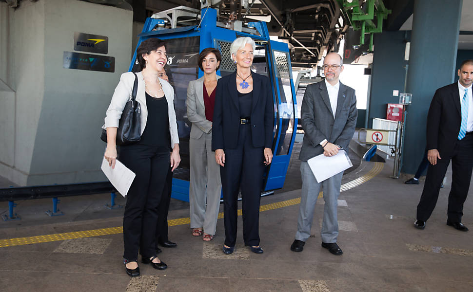 A diretora-gerente do FMI, Christine Lagarde e a Ministra do desenvolvimento, Tereza Campello (de cinza), em visita ao Complexo do Alemão, onde chagaram de teleférico 