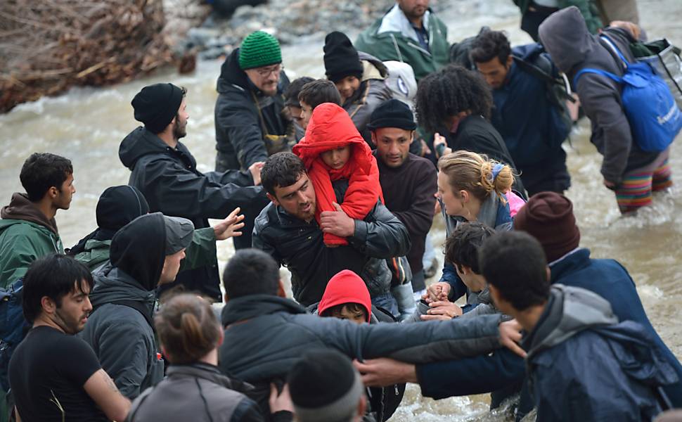 Sírios cruzam rio entre Grécia e Macedônia