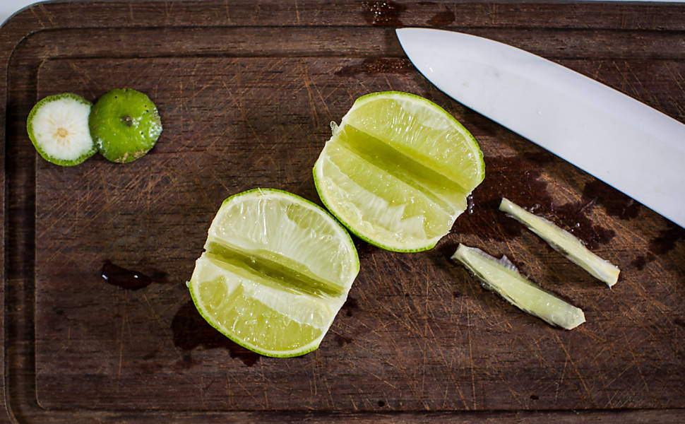 Em uma tábua, corte as pontinhas do limão. Divida no sentido do comprimento 
e retire o miolo (parte branca) de cada parte