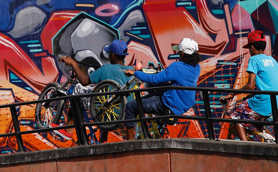 Crianças brincando de bicicleta em Medellín, Colômbia