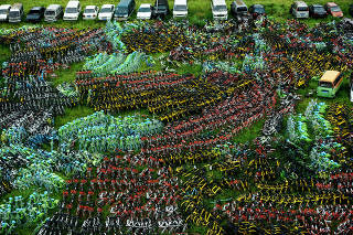 Bicycles of various bike-sharing services are seen at an urban village in Hangzhou