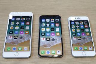 Different iPhone 8 models are displayed during an Apple launch event in Cupertino