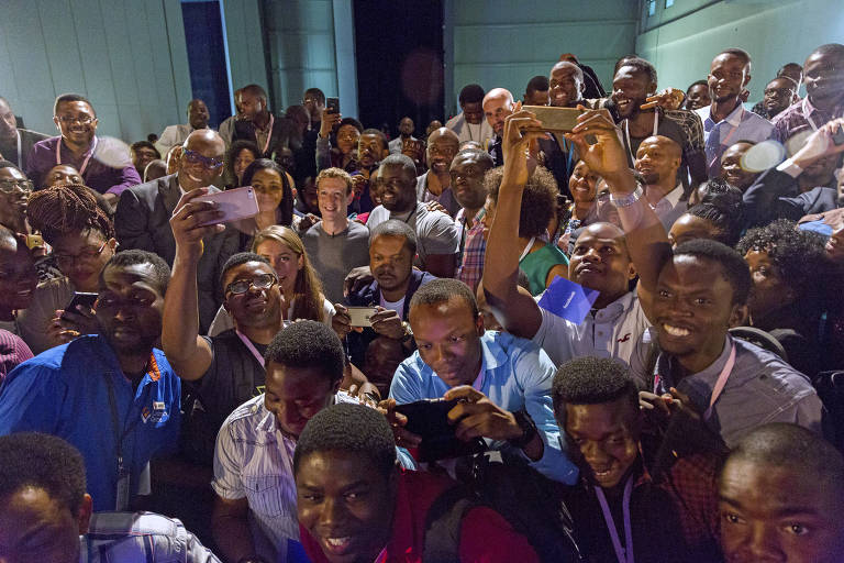 FILE -- Mark Zuckerberg, center, smiles as photos are taken as he stands amidst attendees at a meeting with software developers and entrepreneurs, in Lagos, Nigeria, Aug. 31, 2016. Facebook and other tech companies are increasingly forced to navigate a web that is not as open as it once was, with nation-states exerting their power over the internet. (Andrew Esiebo/The New York Times) ORG XMIT: XNYT67
