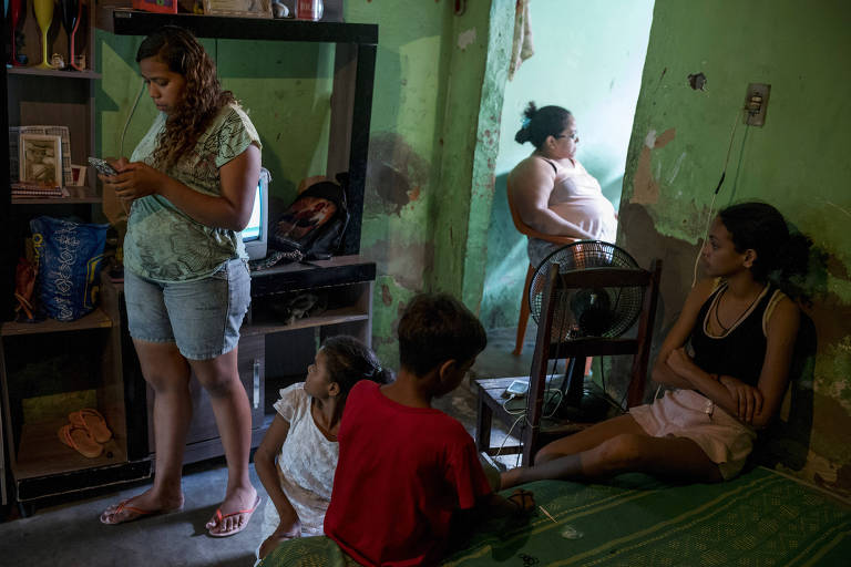 Celene da Silva, uma das milhares de vendedoras de porta em porta da Nestlé, com os filhos e uma prima em sua casa em Fortaleza