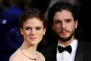FILE PHOTO - Actor Kit Harington and actress Rose Leslie pose for photographers as they arrive at the Olivier Awards at the Royal Opera House in London