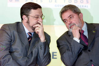 Palocci e Lula durante cerimonia