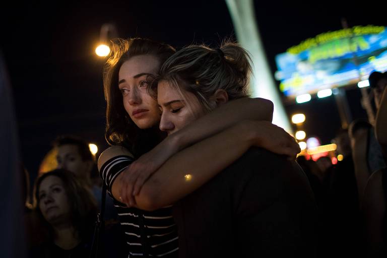 LAS VEGAS, NV - OCTOBER 2: Mourners attend a candlelight vigil at the corner of Sahara Avenue and Las Vegas Boulevard for the victims of Sunday night's mass shooting, October 2, 2017 in Las Vegas, Nevada. Late Sunday night, a lone gunman killed more than 50 people and injured more than 500 people after he opened fire on a large crowd at the Route 91 Harvest Festival, a three-day country music festival. The massacre is one of the deadliest mass shooting events in U.S. history. 