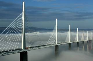 Pillars from the Millau Viaduct rise above clouds over the river Tarn in France