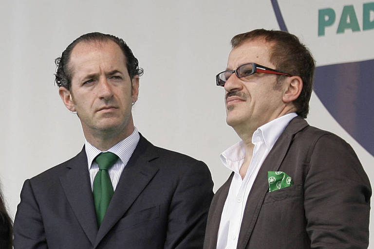 In this Sunday, June 1, 2008 file photo, Roberto Maroni, left, and Luca Zaia attend the annual meeting of the Lega Nord, Northern League party, in Pontida, Italy. It is greater autonomy, not independence, that two of Italy?s wealthiest regions are seeking in a pair of referendums Sunday, yet Catalonia?s secessionist ambitions loom over the debate. The president of Lombardy, Roberto Maroni and Veneto, Luca Zaia, are campaigning on the economic benefits of loosening Rome?s grip. But identity politics also is playing a role, particularly in Veneto, where a political fringe has never given up on the secession course long abandoned by the governing Northern League. (AP Photo/Alberto Pellaschiar, Files) ORG XMIT: MIL101