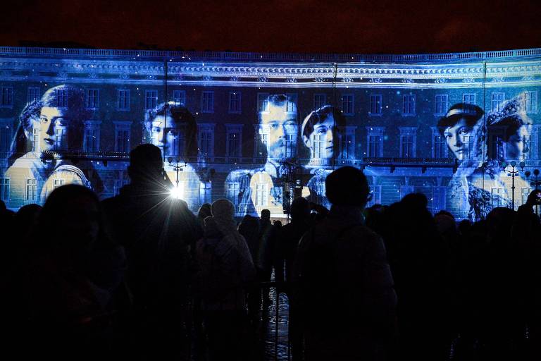 Pessoas assistem a um show de mapeamento em 3D com imagens da família do último imperador russo Nicolas II na Praça Dvortsovaya, em São Petersburgo