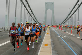 The first wave of runners make their way across the Verrazano-Narrows Bridge during the start of the New York City Marathon in New York