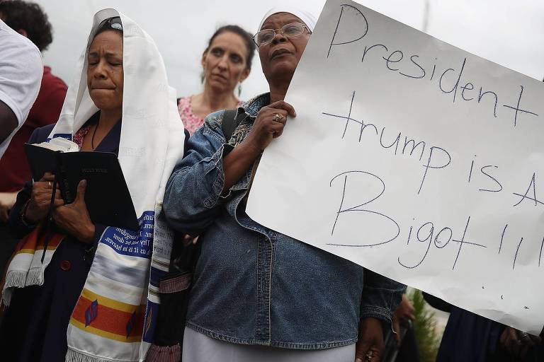A pastora Lorna Shuford participa de ato contra Trump com cartaz com a frase "Trump é preconceituoso"