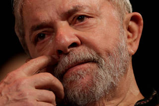 FILE PHOTO: Brazil's former President Luis Inacio Lula da Silva reacts during an event in support of his candidacy for president in Rio de Janeiro, Brazil