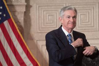 Jerome Powell (R) takes the oath of office as he is sworn-in as the new Chairman of the Federal Reserve