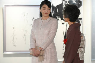 Japanese Princess Mako receives an explanation from calligrapher Hakuyo Kaneoka at a calligraphy exhibition in Tokyo