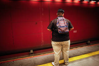 A rider waits on a subway platform in Santiago, Chile.