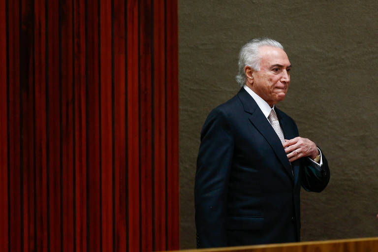 Com a mão no peito, o presidente Temer olha para o público durante cerimônia de posse do novo presidente do TSE, ministro Luiz Fux, no último dia 6