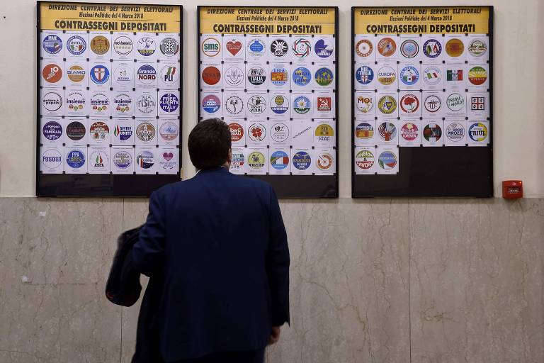 Eleitor observa partidos autorizados a concorrerem nas eleições legislativas da Itália, em 4 de março 