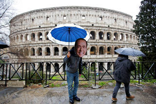 An activist wearing a mask of Forza Italia party leader Silvio Berlusconi poses during a tour, the day after Italy's parliamentary election, in Rome