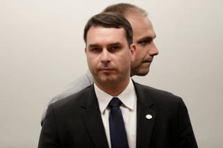 Flavio Bolsonaro (front) is near Eduardo Nantes Bolsonaro, during an affiliation ceremony of the Federal deputy Jair Bolsonaro, a pre-candidate for Brazil's presidential elections, joins the Liberal Social Party (PSL) in Brasilia