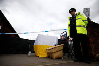 A police officer stands at a cordon placed around a payment machine covered by a tent in a supermarket car park near to where former Russian intelligence agent Sergei Skripal and his daughter Yulia were found poisoned in Salisbury